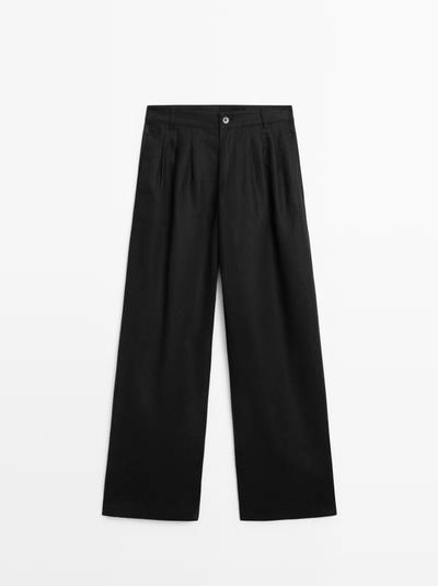 Широкие льняные брюки с защипами - studio