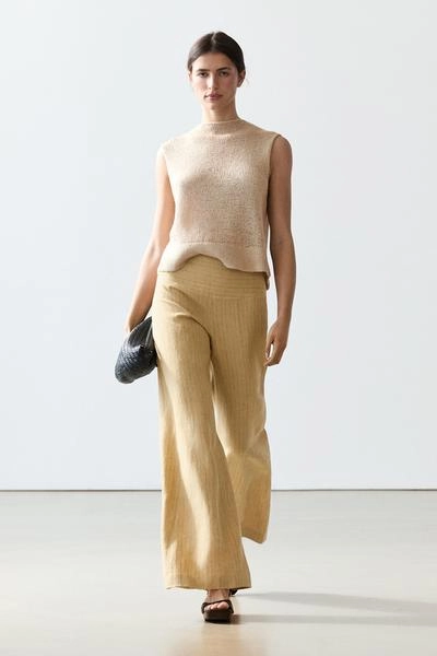 Брюки из льна с расширяющимся кроем и полосатыми деталями- Заказать в России