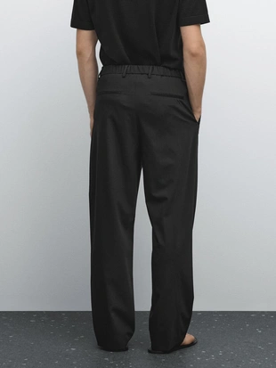 Брюки свободного кроя с деталями втачных складок- Заказать в России