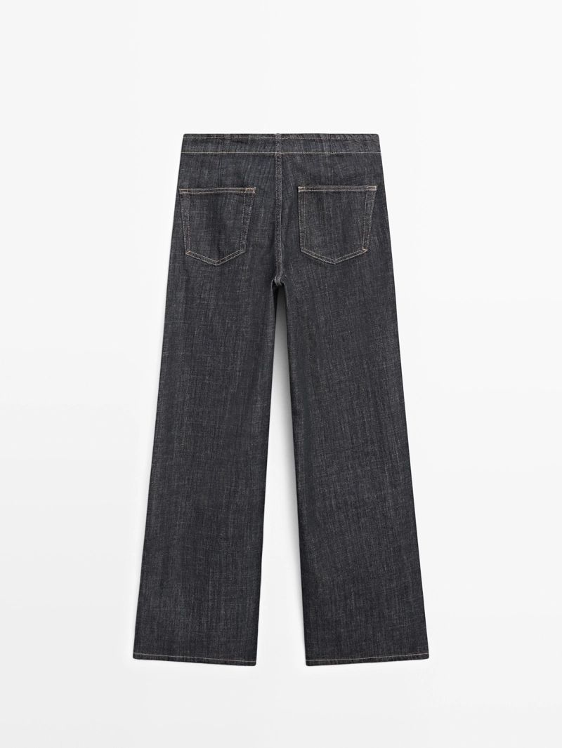 Джинсы с высокой талией и широкими штанинами с цепями