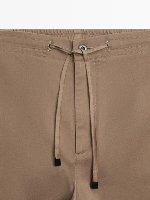 Хлопковые брюки в стиле джоггер из смесовой ткани- Заказать в России