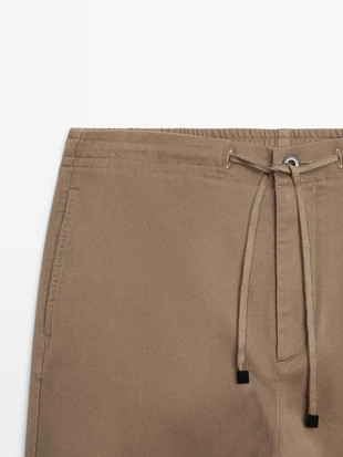 Хлопковые брюки в стиле джоггер из смесовой ткани- Заказать в России