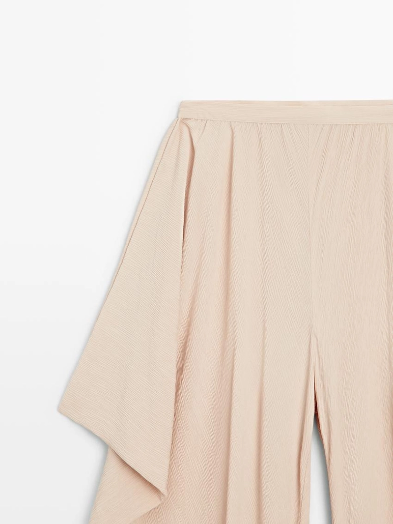 Потоковые объемные брюки