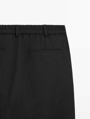 Брюки из шерсти свободного кроя с защипами- Заказать в России