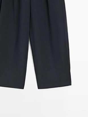 Брюки с плиссированными деталями из плавной ткани- Заказать в России