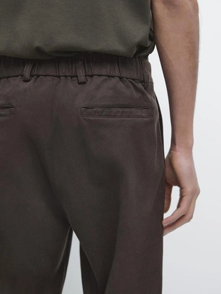 Брюки свободного кроя из хлопкового смесового материала- Заказать в России