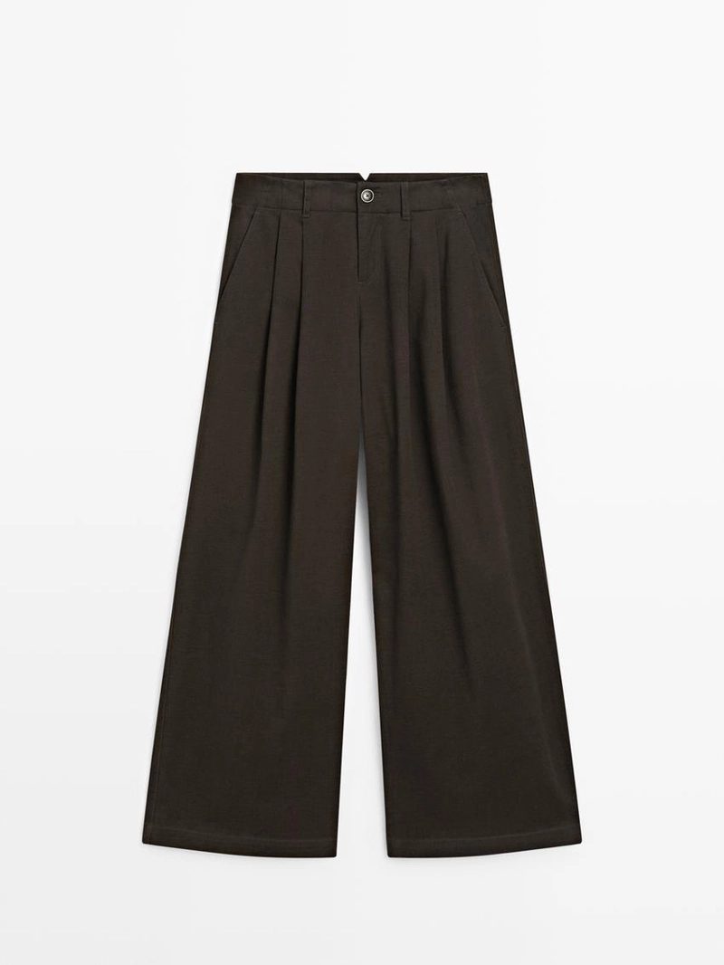 Брюки с широкими штанинами и защипами