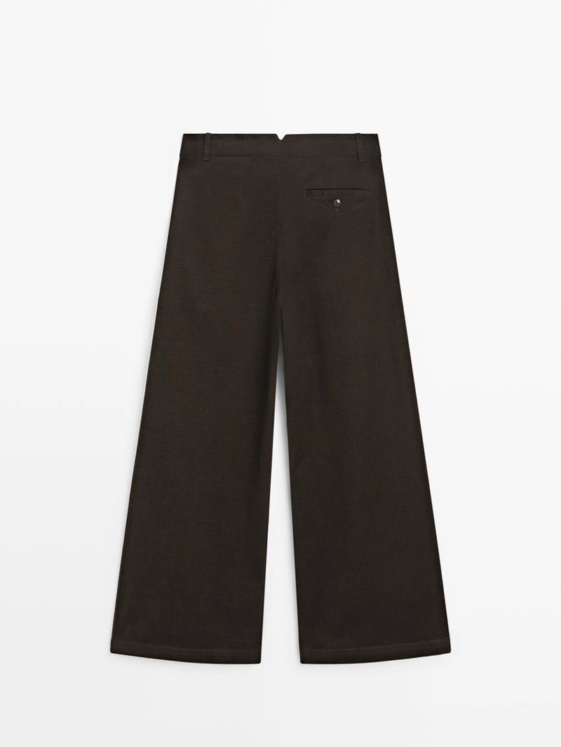 Брюки с широкими штанинами и защипами