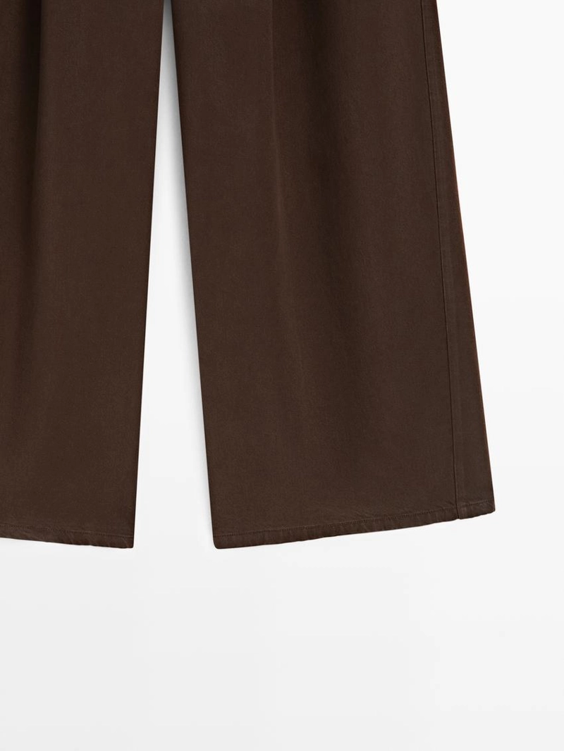 Широкие зауженные брюки с защипами