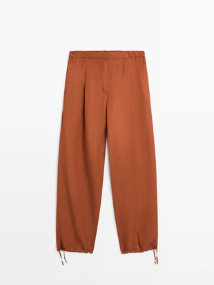 Брюки со свободным кроем и деталью на завязке- Заказать в России