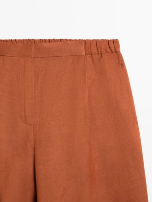 Брюки со свободным кроем и деталью на завязке- Заказать в России