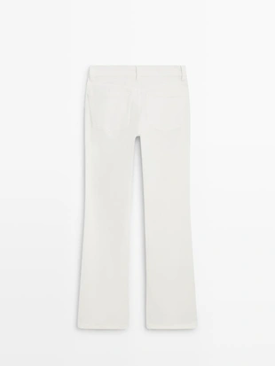 Джинсы с узкими брючинами и расширенным низом- Заказать в России