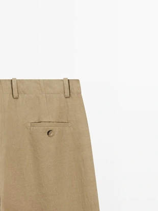 Брюки с защипами и пересекающимся застежкой - studio- Заказать в России