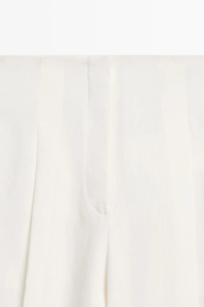 Брюки из льна с драпировкой и манжетами на резинке