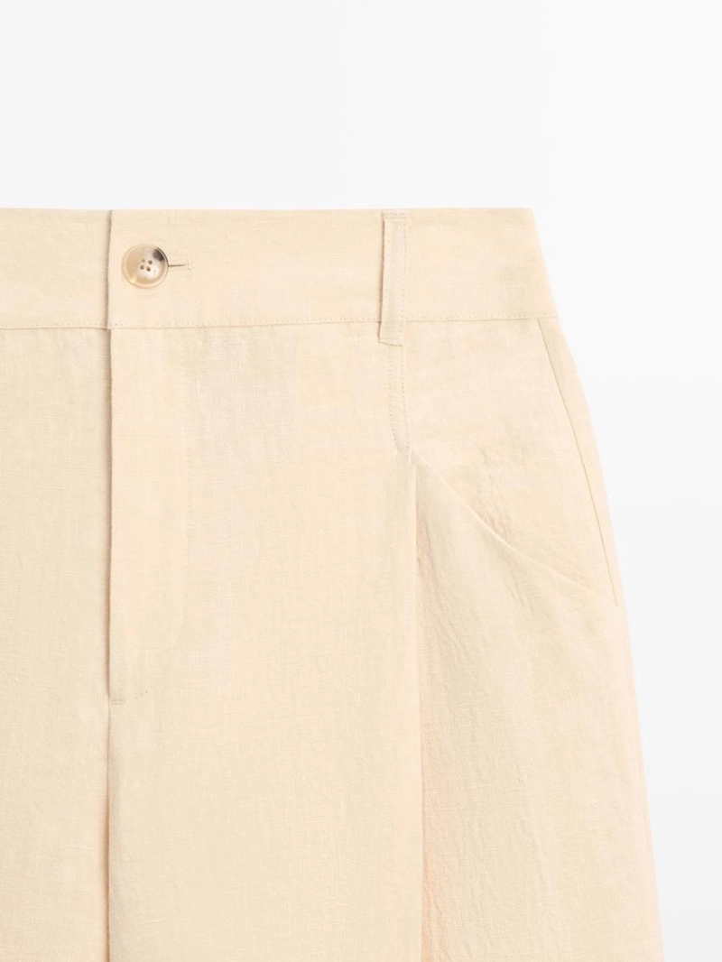 Широкие льняные брюки с карманами