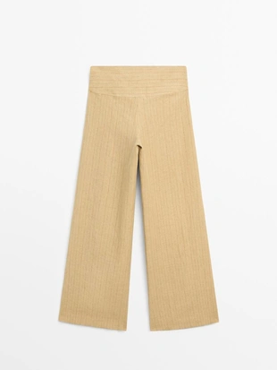 Брюки из льна с расширяющимся кроем и полосатыми деталями- Заказать в России