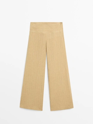 Брюки из льна с расширяющимся кроем и полосатыми деталями- Заказать в России